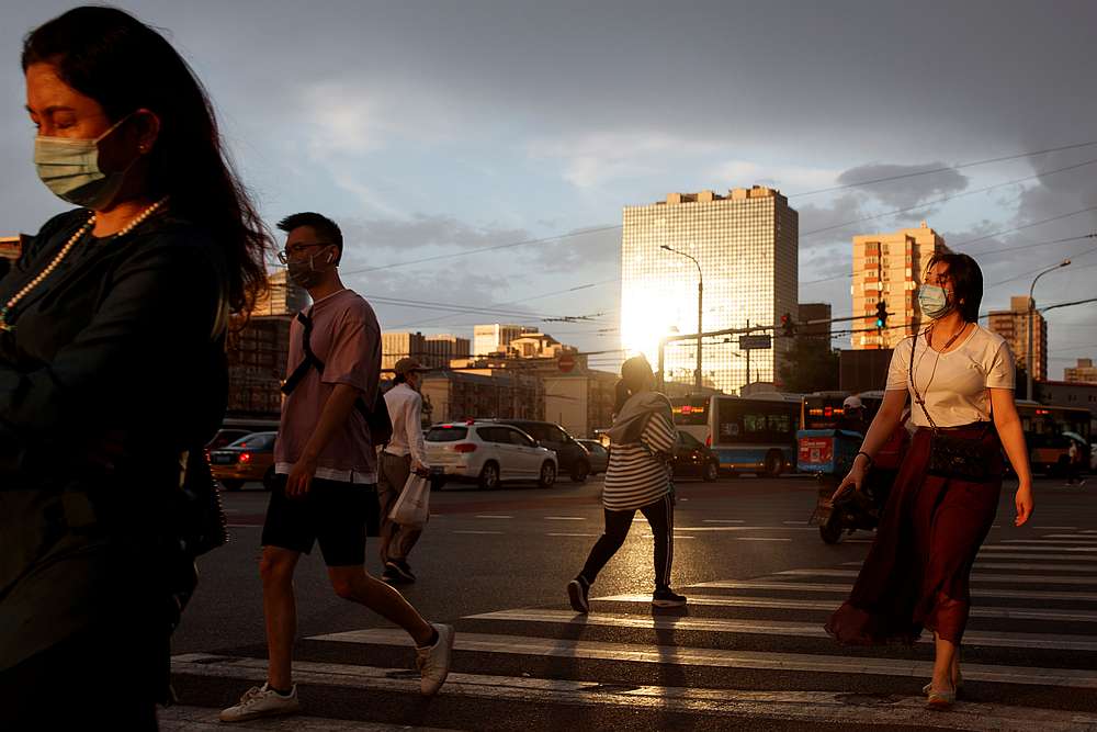 People wear protective masks as they cross a street following the Covid-19 outbreak in Beijing, China May 28, 2020. u00e2u20acu201d Reuters pic