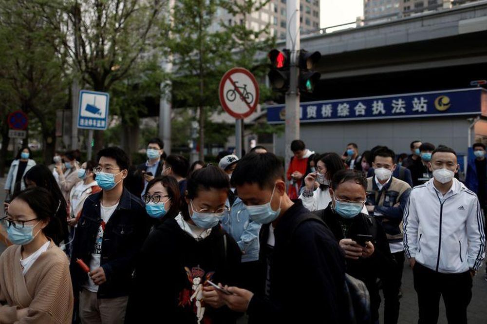 People wearing protective face masks leave work after office hours in Central Business District, as the spread of the new coronavirus disease (Covid-19) continues, in Beijing, China, April 17, 2020. u00e2u20acu201d Reuters pic