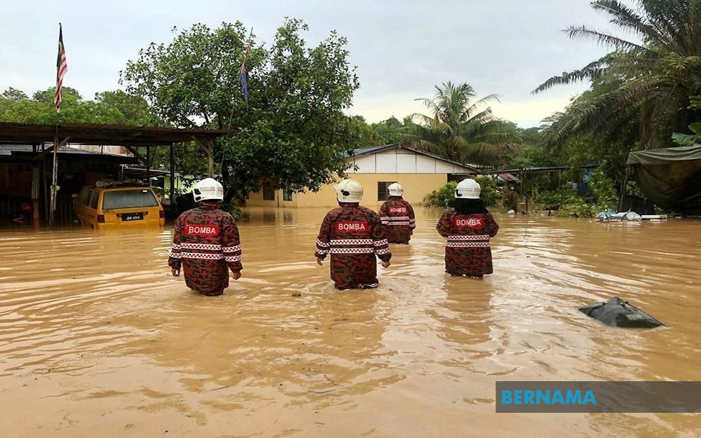 Fire and Rescue Department personnel provide assistance to residents during a flood in Penang May 17, 2020. u00e2u20acu201d Picture via Twitter/Bernama