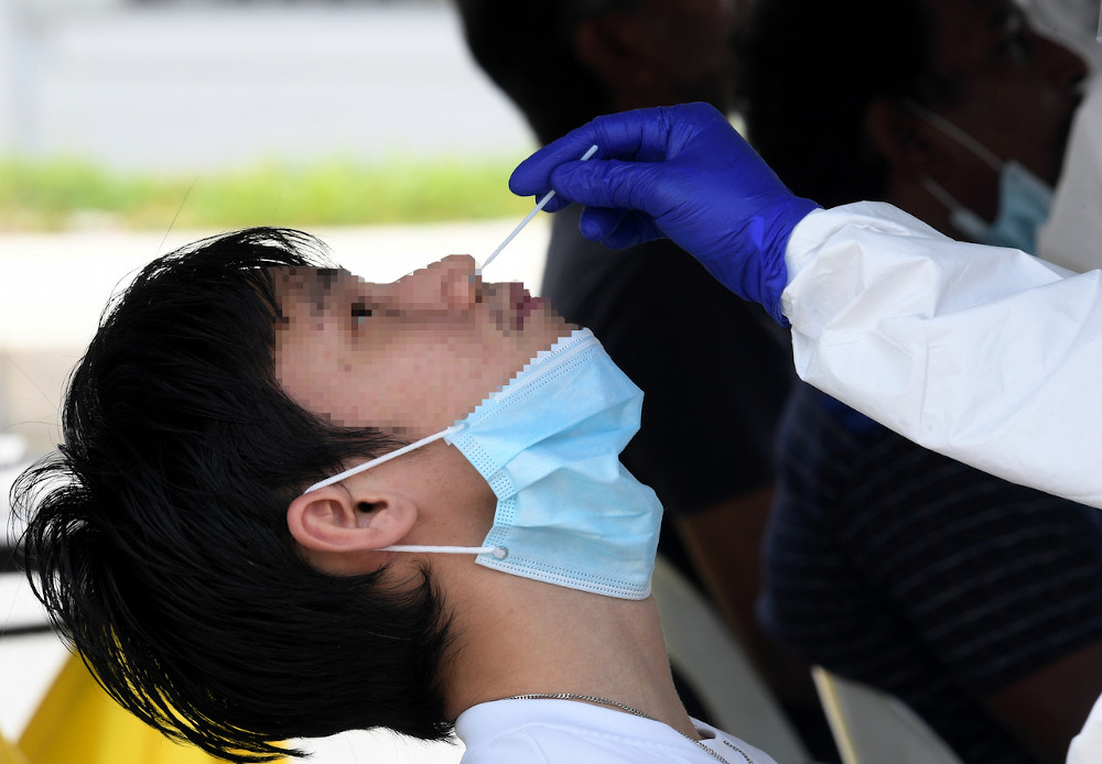 A resident is tested for Covid-19 during the enhanced movement control order at the Jalan Othman market May 10, 2020. u00e2u20acu201d Bernama pic
