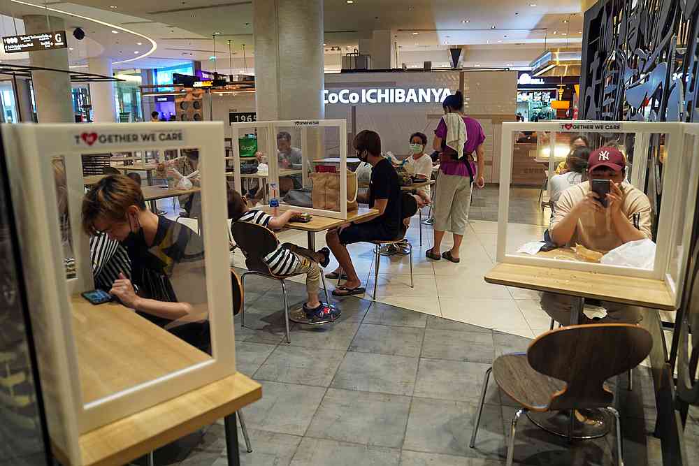 People eat lunch at a food court of a department store, after the Thai government eased isolation measures to prevent the spread of Covid-19, in Bangkok, Thailand May 21, 2020. u00e2u20acu201d Reuters pic