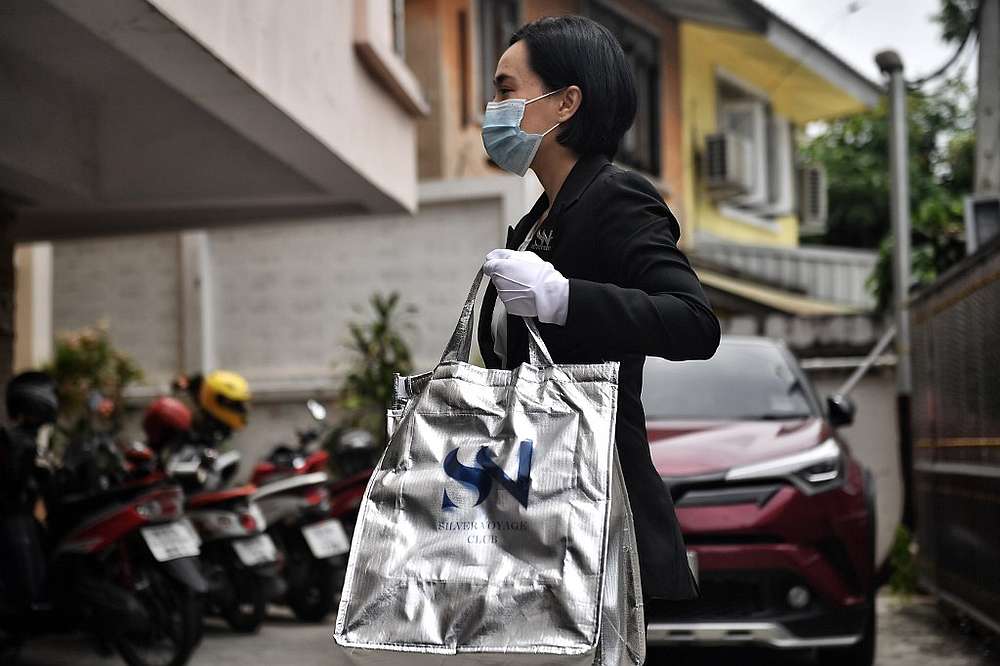 An employee from luxury food delivery service White Glove Delivery bringing an order to a client in Bangkok May 4, 2020. u00e2u20acu201d AFP pic