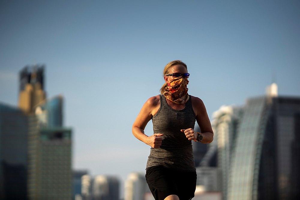 A woman with a face mask runs inside a park in Bangkok, Thailand May 3, 2020. u00e2u20acu201d Reuters pic