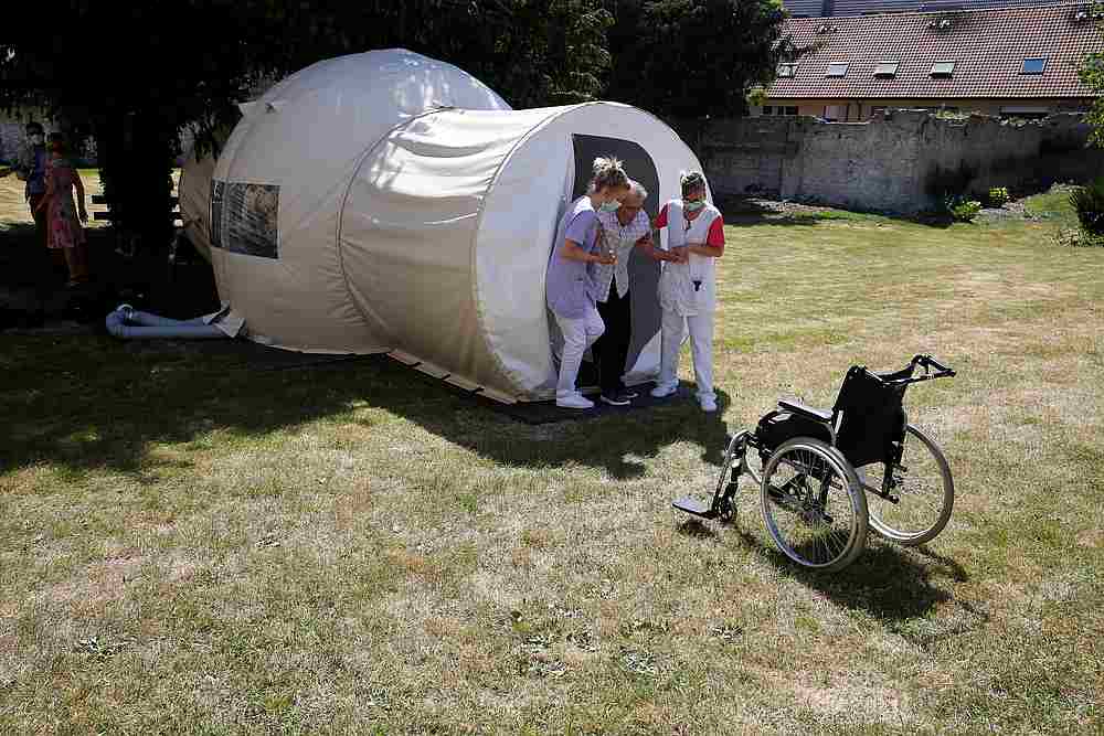 Nurses help a resident to leave a bubble room for visits between residents and their families installed in the garden of the Fondation Shadet Vercoustre retirement home in Bourbourg, France, May 25, 2020. u00e2u20acu201d Reuters pic