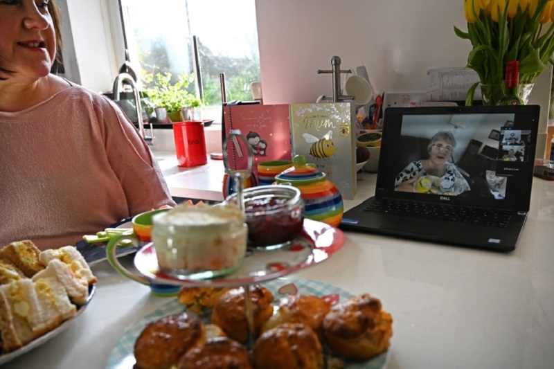 A family in Birkenhead, north west England speak to their mother and grandmother online via a laptop computer with an afternoon tea to celebrate Mother's Day. u00e2u20acu2022 AFP pic