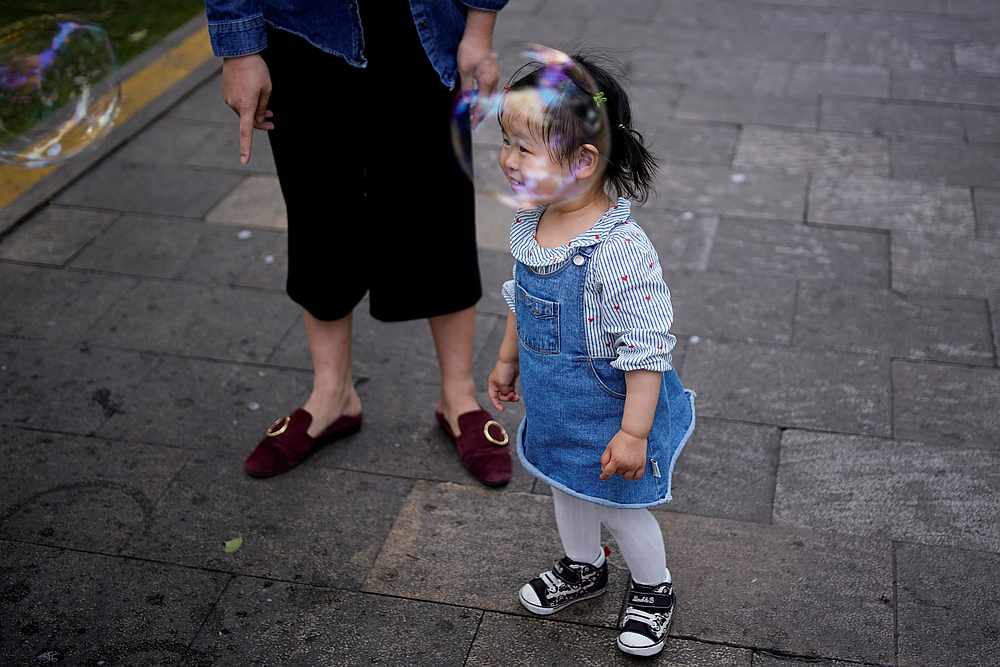 A little girl plays soap bubbles at a park following an outbreak of Covid-19, in Shanghai, China May 19, 2020. u00e2u20acu201d Reuters pic