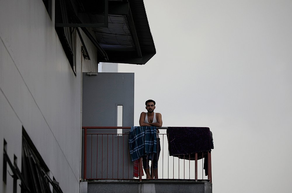 A migrant worker looks on outside his room in a factory-converted dormitory, ahead of the Hari Raya celebrations amid the Covid-19 outbreak in Singapore May 24, 2020. u00e2u20acu201d Reuters pic
