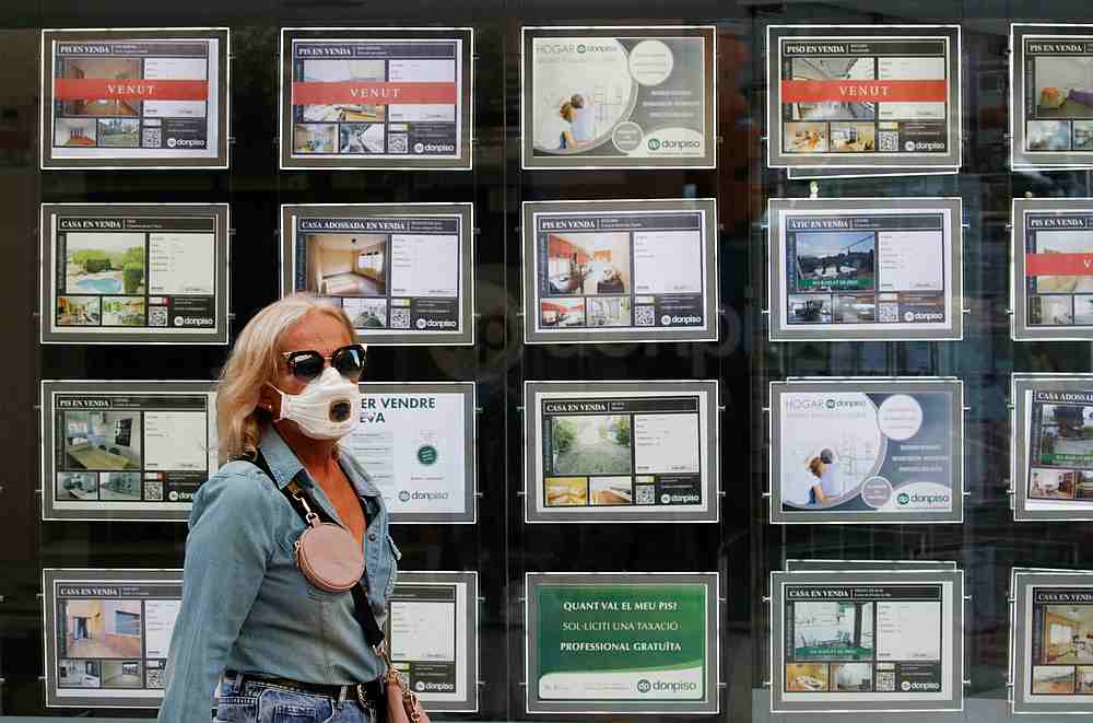 A woman wearing a face mask walks past a Don Piso real estate agency office during the Covid-19 outbreak in El Masnou, north of Barcelona, Spain, May 19, 2020. u00e2u20acu201d Reuters pic