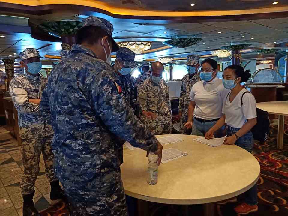 Philippine Coast Guard staff hold a meeting inside the Carnival Spirit cruise ship docked at Manila Bay's anchorage, Philippines May 8, 2020. u00e2u20acu201d Philippine Coast Guard handout via Reuters