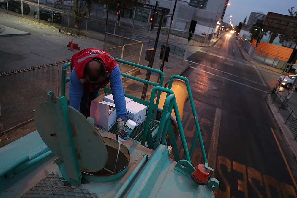 A worker discharges disinfectant into a water container of a truck used in the mining industry, to fight the spread of Covid-19 n Santiago, Chile May 12 2020. u00e2u20acu201d Reuters pic