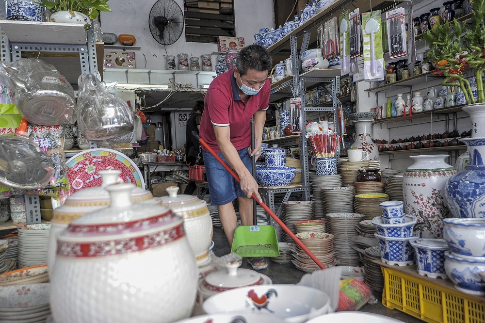 Chan Kan Woh, of Chi Shang Mei Enterprises, is seen cleaning his shop on Petaling Street, Kuala Lumpur May 4, 2020. u00e2u20acu2022 Picture by Shafwan Zaidonn
