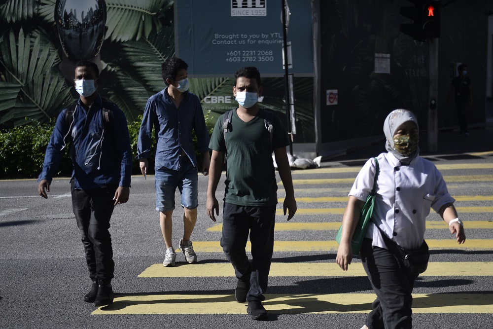 Pedestrians are seen walking on the streets of Kuala Lumpur on first day of CMCO, May 4, 2020. u00e2u20acu2022 Picture by Miera Zulyana
