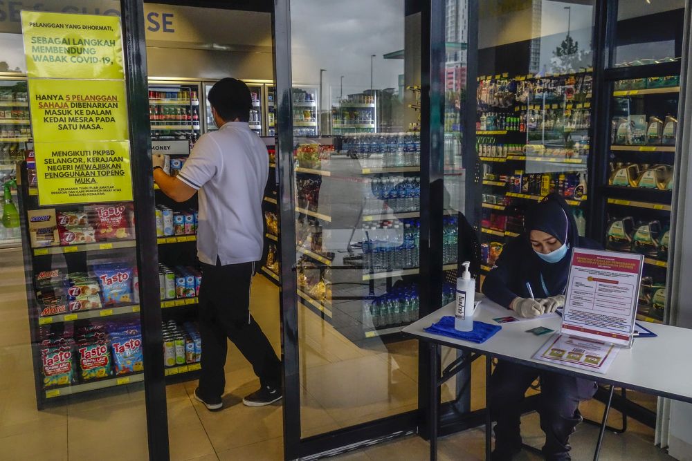 Notices detailing standard operating procedures during the conditional movement control order are displayed at the entrance of a convenience store in Kuala Lumpur May 12, 2020.u00e2u20acu201d Picture by Shafwan Zaidon