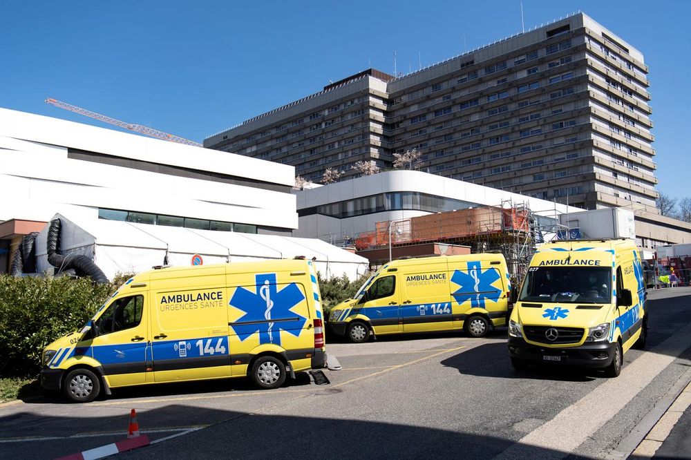 Ambulances are pictured in front of a temporary space for patients at the University Hospital (CHUV) during the coronavirus outbreak in Lausanne, Switzerland, March 31, 2020. u00e2u20acu201d Laurent Gillieron/Pool via Reuters