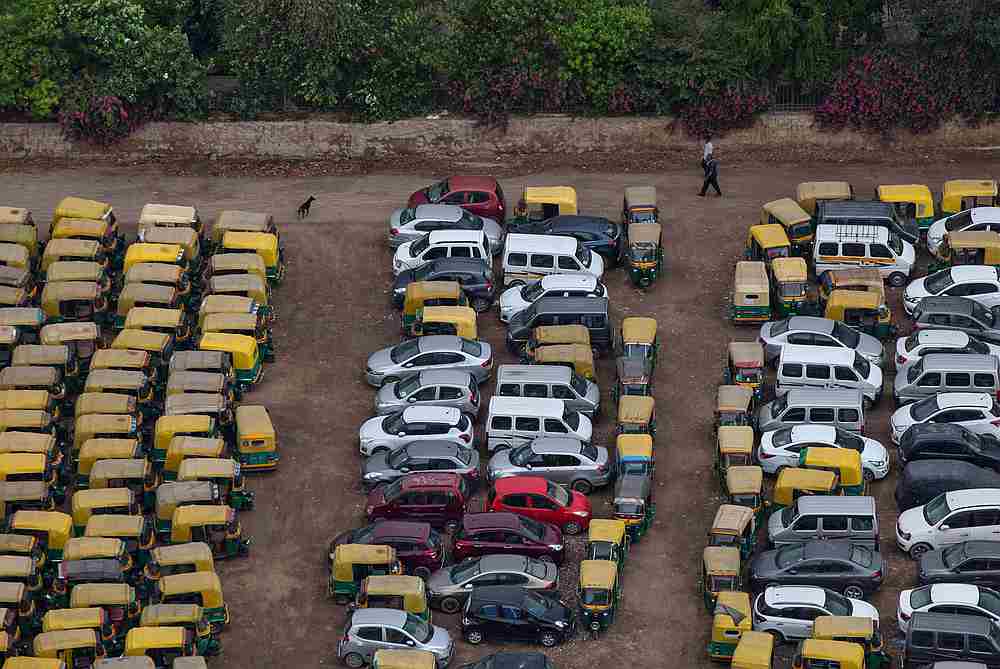 People walk past parked autos and cars in a parking during an extended nationwide lockdown to slow the spread of Covid-19 in New Delhi, India May 3, 2020. u00e2u20acu201d Reuters pic