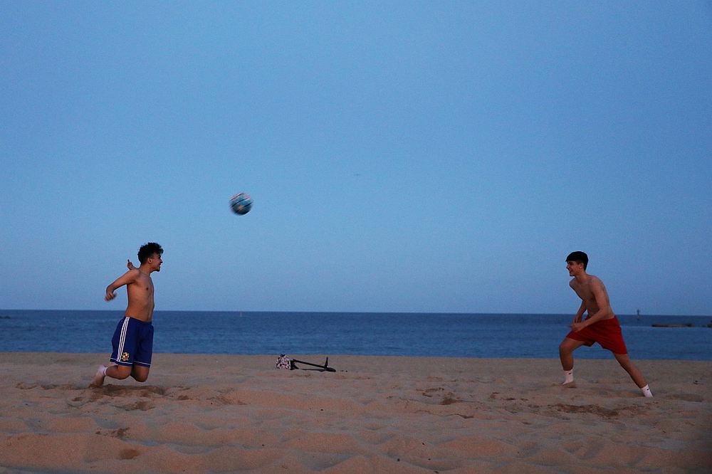 Men play with a ball on Barceloneta beach, as some Spanish provinces are allowed to ease lockdown restrictions during phase one, in Barcelona, Spain May 25, 2020. u00e2u20acu201d Reuters pic
