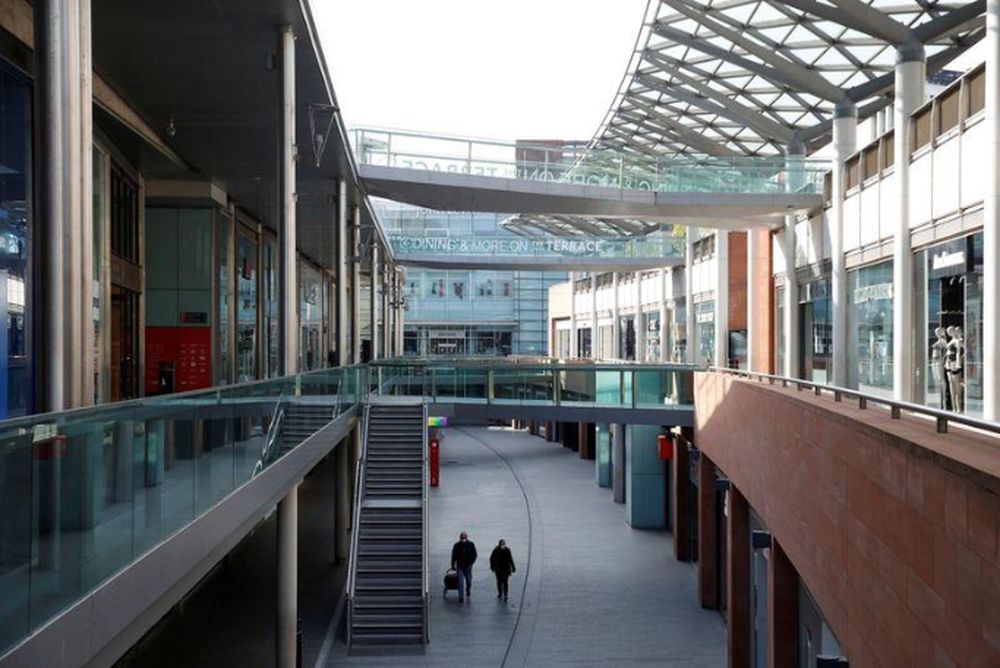 People wearing masks walk through a empty shopping area in Liverpool, as the spread of the coronavirus disease (Covid-19) continues, Liverpool, Britain, April 19, 2020. u00e2u20acu201d Reuters pic