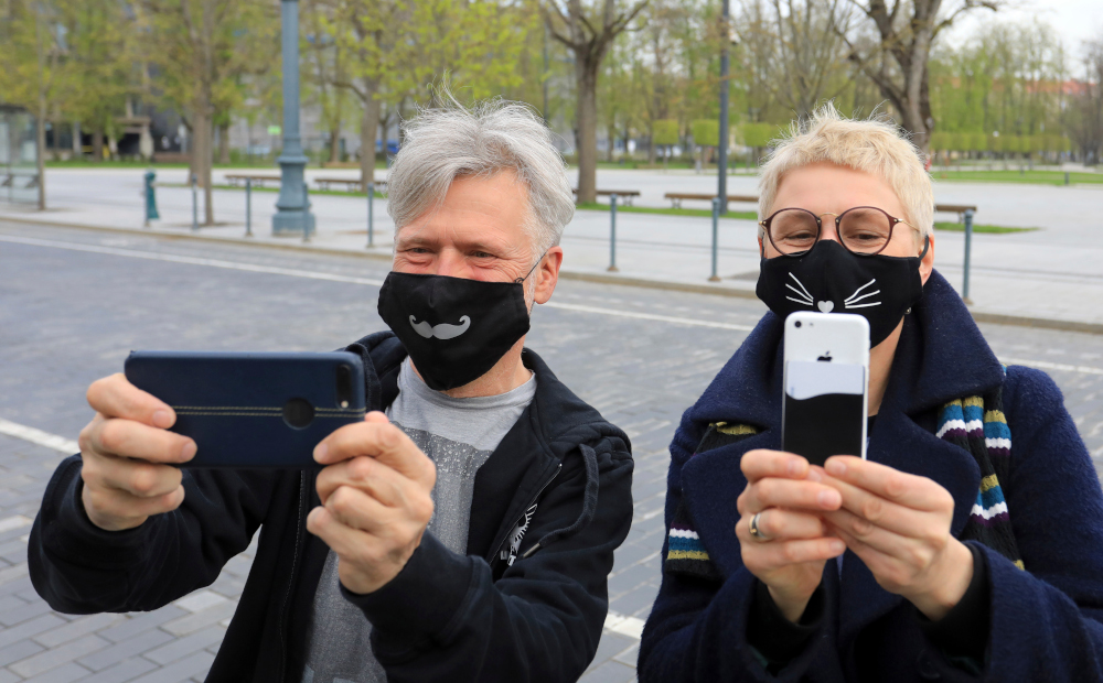People wearing face masks take selfies as they take part in the u00e2u20acu02dcMask Fashion Weeku00e2u20acu2122 in Vilnius May 5, 2020. u00e2u20acu201d AFP pic