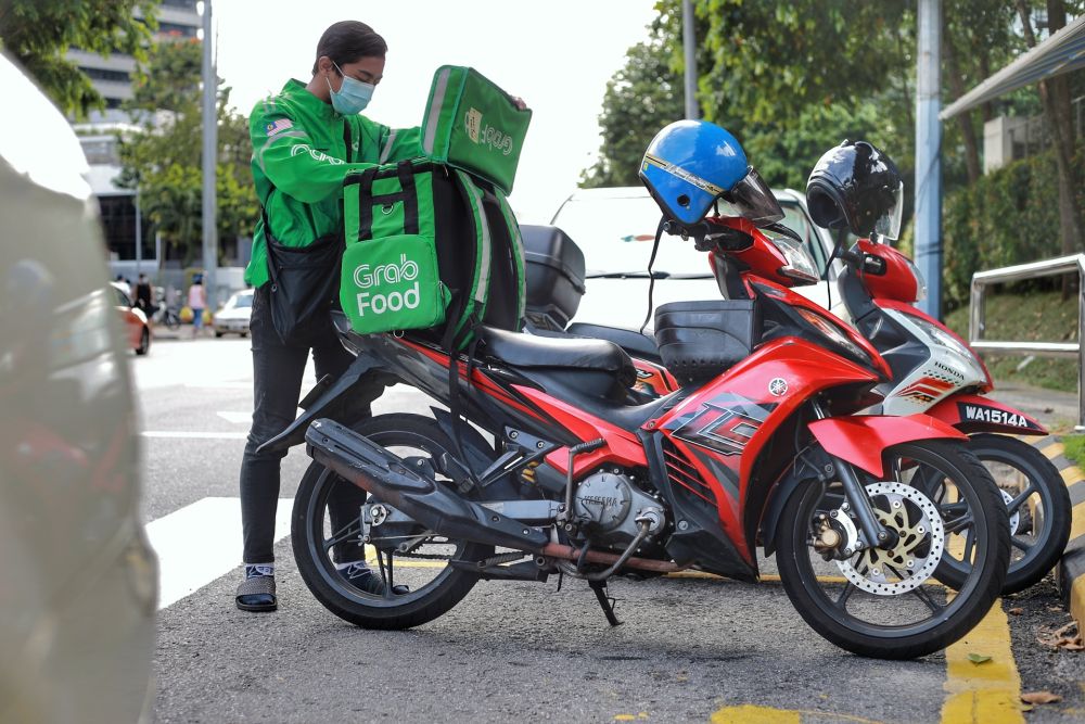 Food delivery rider Zaim Zafran, 21, is pictured at the Taman Tun Dr Ismail wet market May 6, 2020. u00e2u20acu201d Picture by Ahmad Zamzahuri