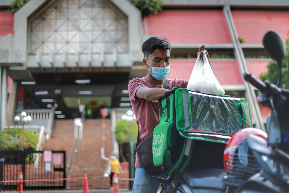 Food delivery rider Azhar Khairuddin, 21, is pictured at the Taman Tun Dr Ismail wet market May 6, 2020. 