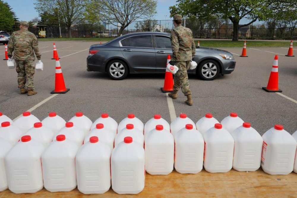 Members of the Massachusetts Army National Guard distribute free milk, offered instead of dairy farmers throwing away excess milk due to lower demand amid the Covid-19) outbreak, in Boston, Massachusetts, May 7, 2020. u00e2u20acu201d Reuters pic
