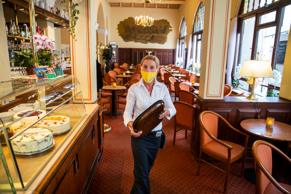 Antje Roesler works the tables at the reopened Cafe Prag in Schwerin, north-eastern Germany May 9, 2020 amid the ongoing Covid-19, coronavirus pandemic. u00e2u20acu201d AFP pic 