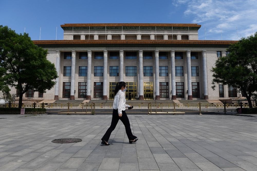 A woman walks past the Great Hall of the People, the venue for the annual meeting of the National Peopleu00e2u20acu2122s Congress, Chinau00e2u20acu2122s rubber-stamp legislature in Beijing on May 20, 2020. u00e2u20acu201d AFP pic