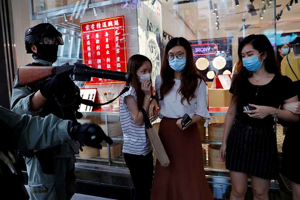 Riot police disperse anti-government protesters during a lunch time protest in Central, as a second reading of a controversial national anthem law takes place in Hong Kong May 27, 2020. u00e2u20acu201d Reuters pic