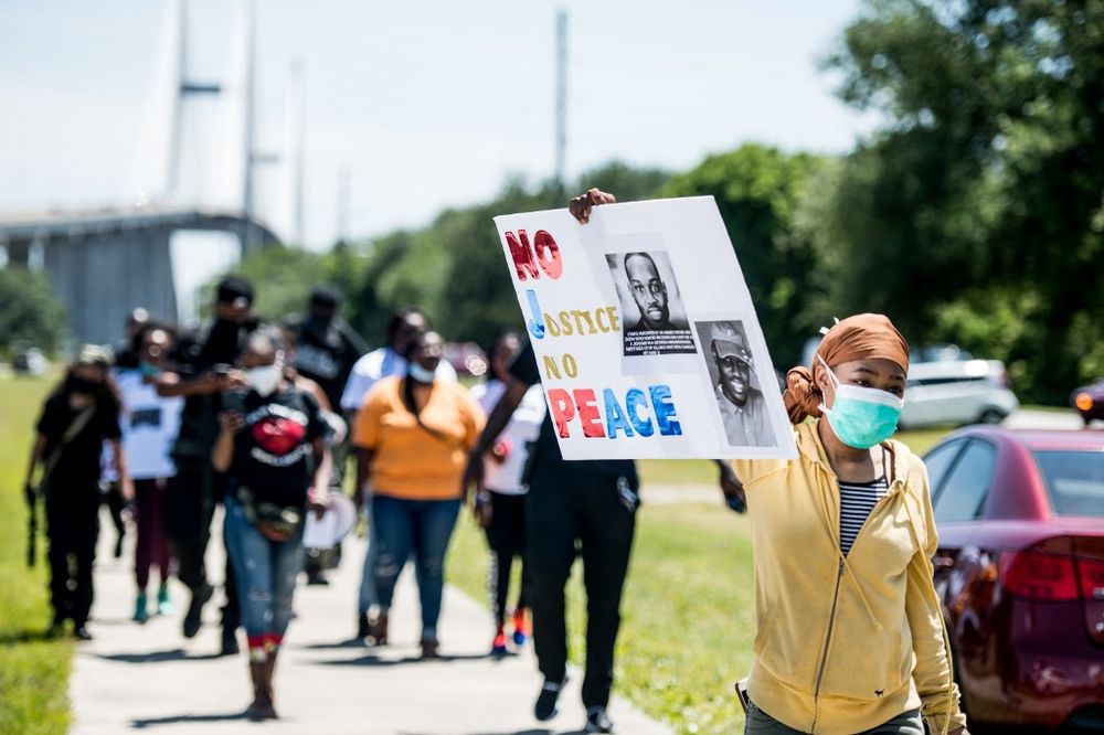 People return to their vehicles after gathering to honour the life of Ahmaud Arbery at Sidney Lanier Park on May 9, 2020 in Brunswick, Georgia. u00e2u20acu201d AFP pic