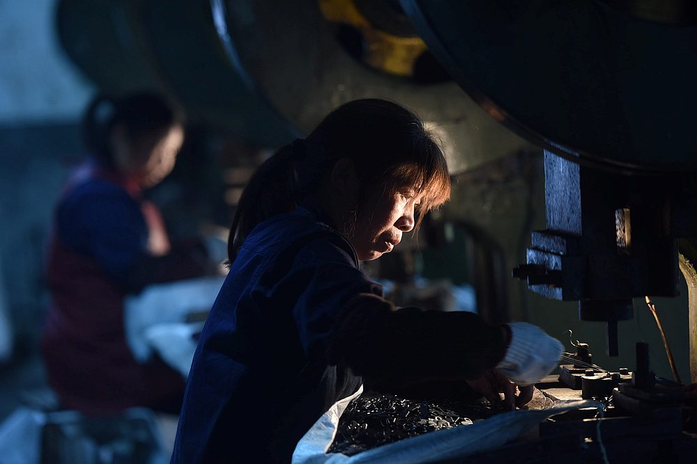 Employees work on a production line manufacturing metal parts for furniture at a factory in Hangzhou, Zhejiang province, China April 30, 2020. u00e2u20acu201d China Daily pic via Reuters