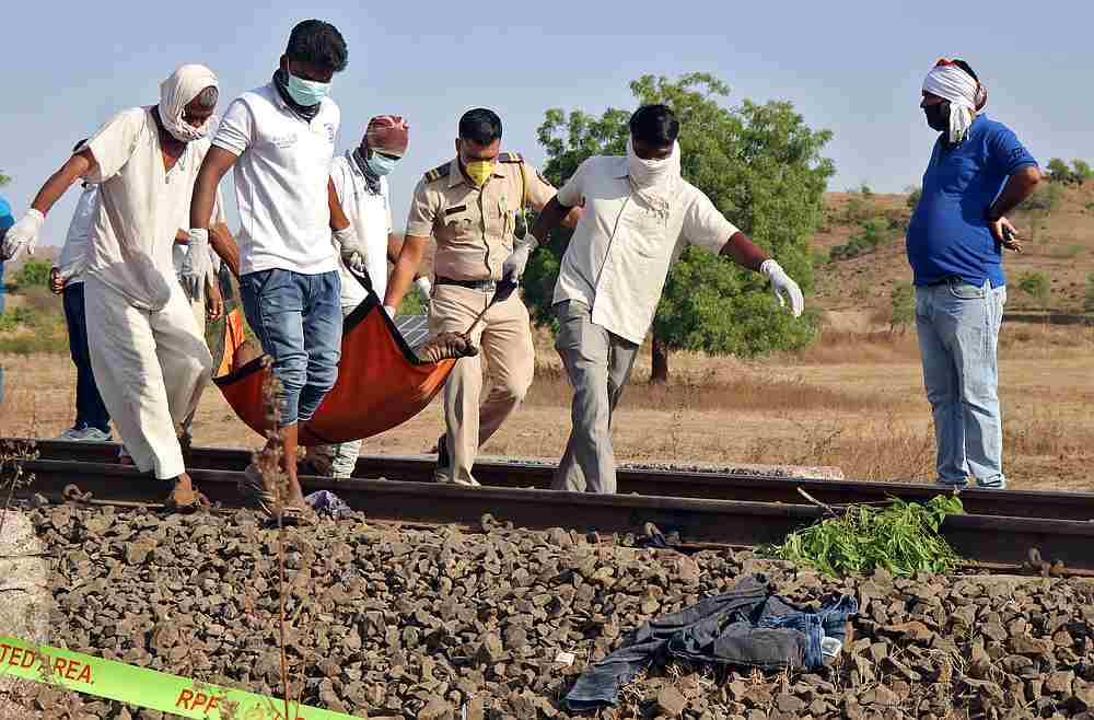 People carry the body of a victim after a train ran over migrant workers sleeping on the track in Aurangabad district in the western state of Maharashtra, India May 8, 2020. u00e2u20acu201d Reuters