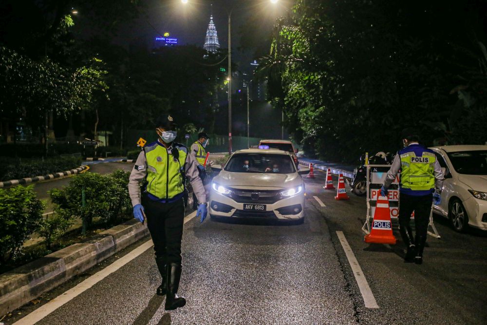 Traffic police personnel man a roadblock on Jalan Raja Laut in Kuala Lumpur May 30, 2020. u00e2u20acu201d Picture by Hari Anggara