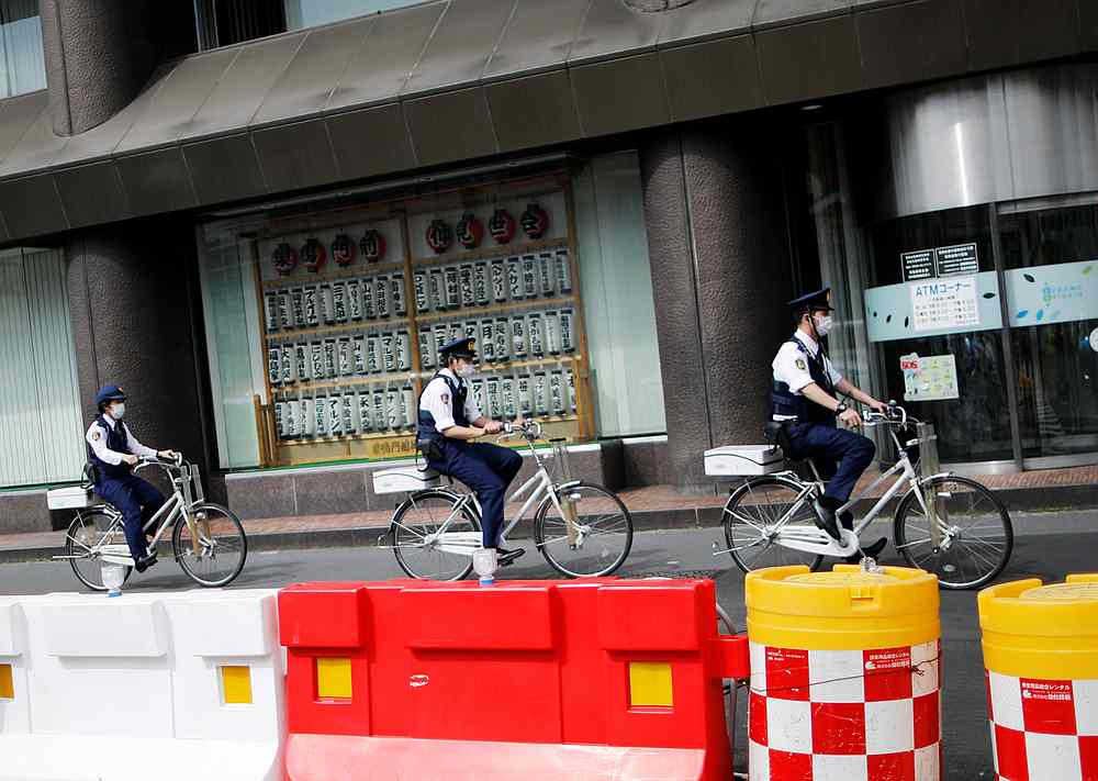 Police officers wearing protective face masks ride bicycles on the street under a nationwide state of emergency in Tokyo, Japan May 10, 2020. u00e2u20acu201d Reuters pic