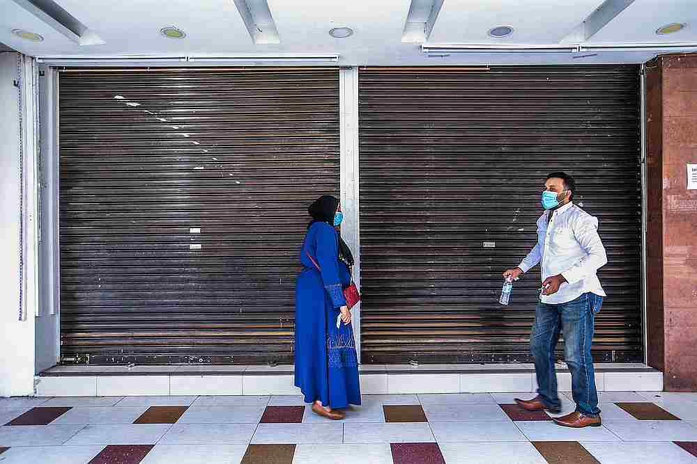 A textile desingner M. Iqbal (right) decides to close his shop after a quiet day at Jalan Tuanku Abdul Rahman, Kuala Lumpur May 4, 2020. u00e2u20acu201d Picture by Hari Anggara