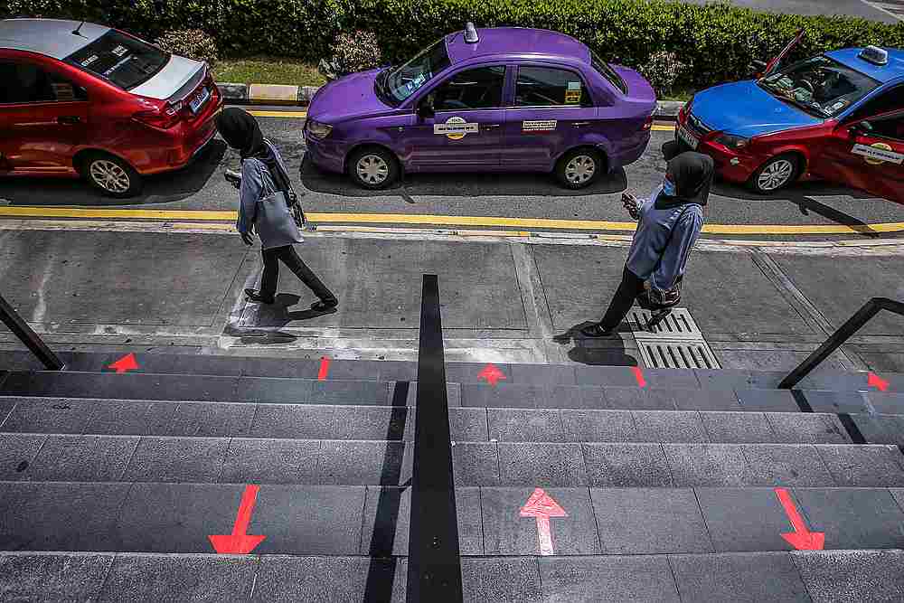 The management of Sogo Shopping Complex has put in place arrow markings to ensure proper social distancing May 4, 2020. — Picture by Hari Anggara