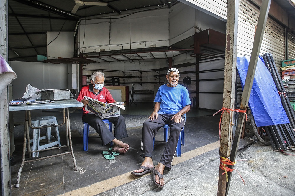 Neighbours Gani Muhammad (left) and Latif Ismail love talking about Kampung Baru's history.