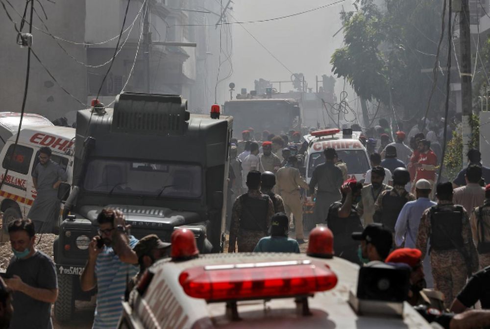 Ambulances and fire brigade vehicles gather at the site of a passenger plane crash in a residential area near an airport in Karachi, Pakistan, May 22, 2020. — Reuters pic