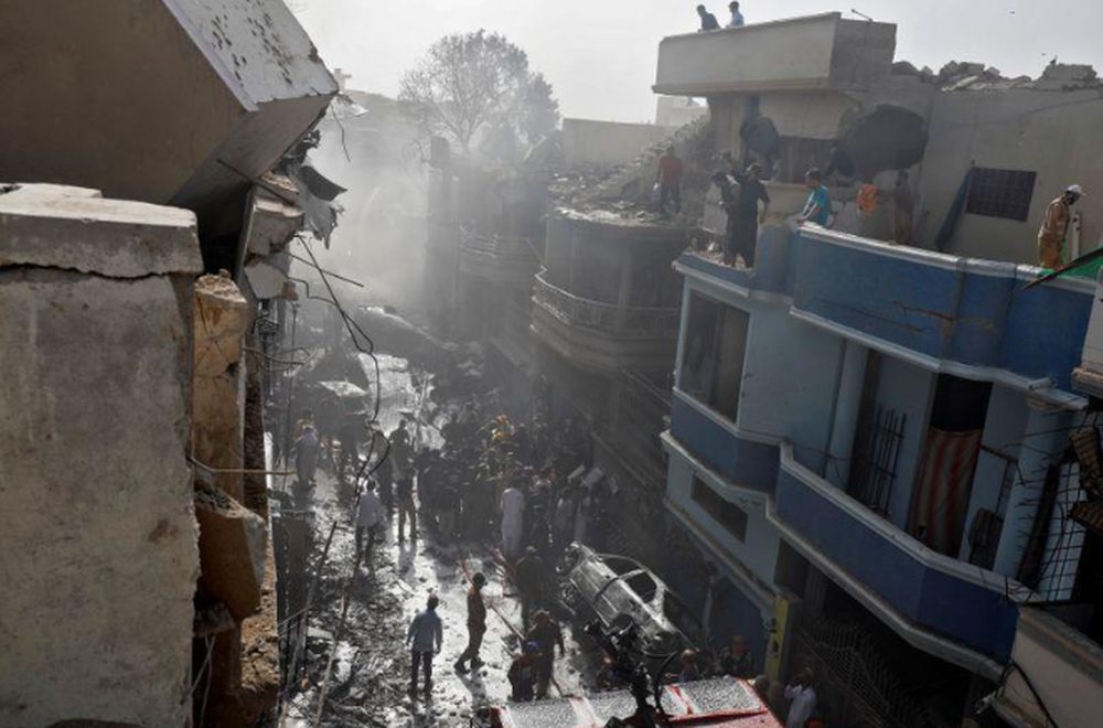 Rescue workers gather at the site of a passenger plane crash in a residential area near an airport in Karachi, Pakistan May 22, 2020. u00e2u20acu201d Reuters pic