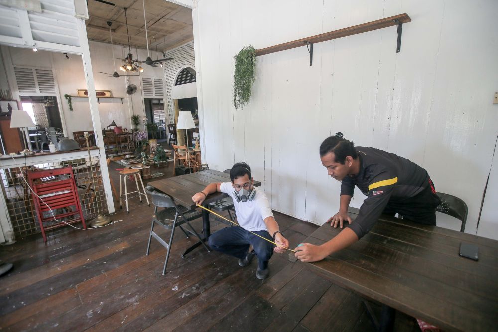 Karat Cafe staff arrange tables to comply with social distancing guidelines within its premises in Ipoh May 3, 2020. u00e2u20acu201d Picture by Firdaus Latif