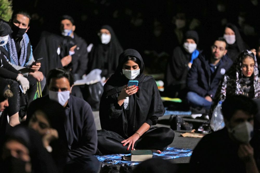 Iranians, some wearing face masks against the Covid-19 coronavirus, attend Laylat al-Qadr prayers, one of the holiest nights during the Muslim fasting month of Ramadan, outside a mosque in the Tehran, on May 13, 2020. u00e2u20acu201d AFP pic
