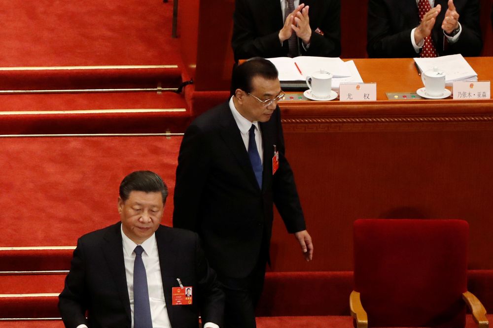 Chinese Premier Li Keqiang returns to his seat next to Chinese President Xi Jinping after his speech at the opening session of the National Peopleu00e2u20acu2122s Congress (NPC) at the Great Hall of the People in Beijing, China May 22, 2020. u00e2u20acu201d Reuters pic