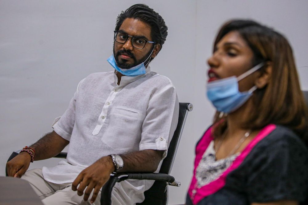 Batu MP P. Prabakaran looks on while single mother Lisa Christina speaks to reporters during a press conference at Pusat Khidmat Rakyat Parliament Batu, Kuala Lumpur May 7, 2020. 