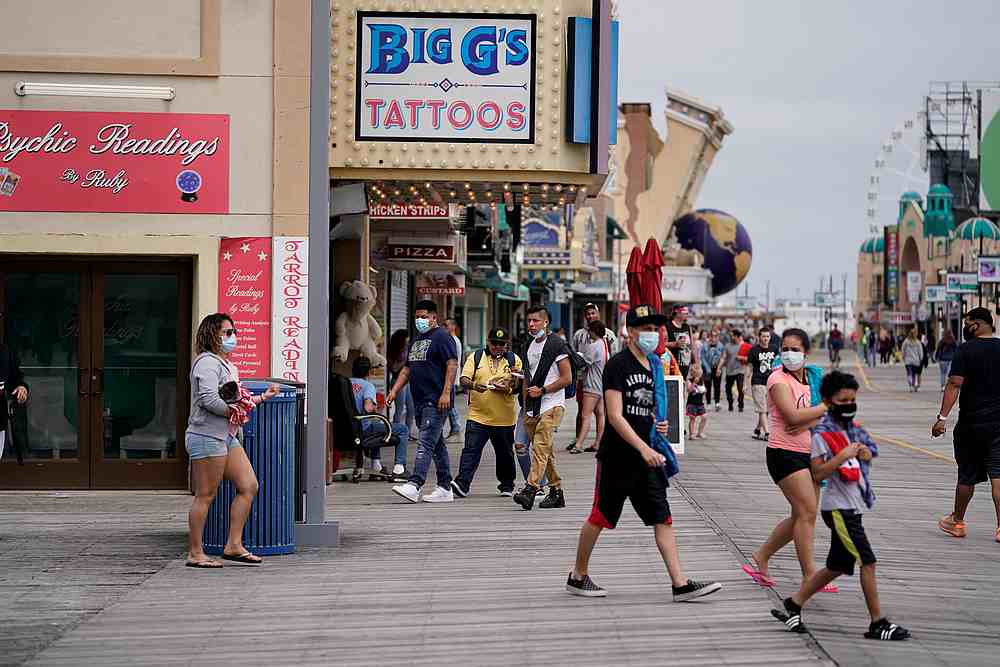 Visitors walk and shop on the boardwalk after Covid-19 restrictions were lifted in time for the Memorial Day weekend in Atlantic City, New Jersey May 25, 2020. u00e2u20acu201d Reuters pic