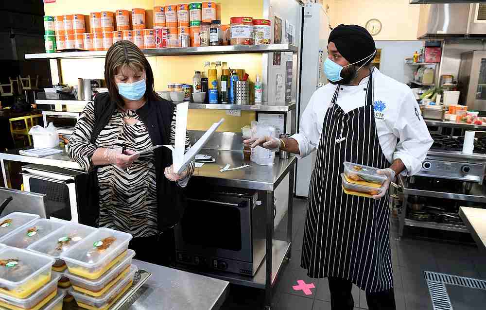Student welfare officer Michelle Cassell (left) speaking with head of hospitality studies Gurpreet Bhatia at the Melbourne City Institute of Education May 22, 2020. u00e2u20acu201d AFP pic