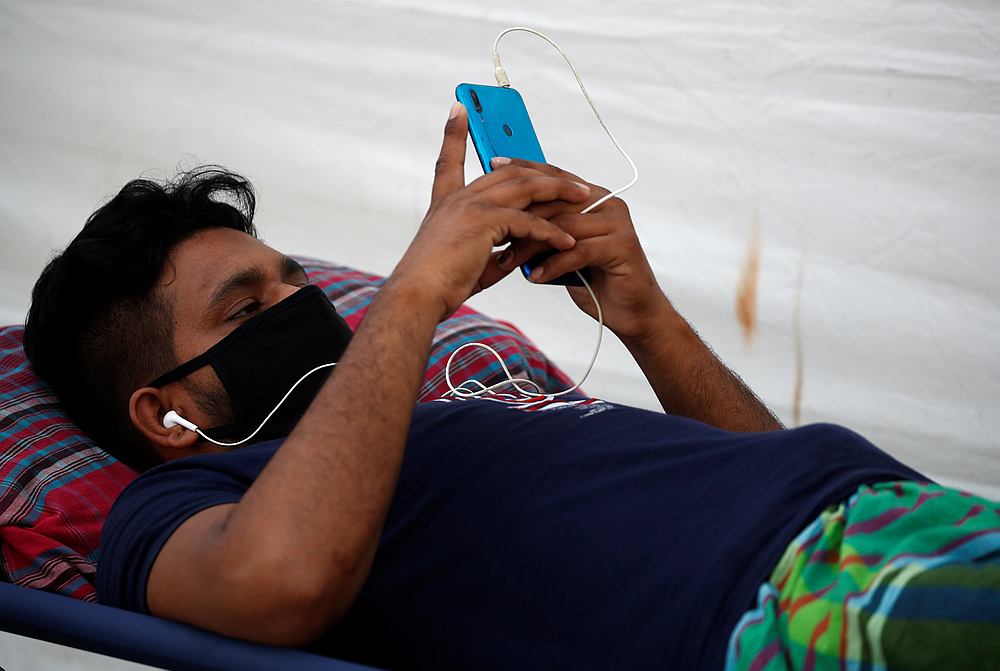 A migrant worker rests at a swab isolation facility as he waits for his swab test results at a dormitory, amid the Covid-19 outbreak in Singapore May 15, 2020. u00e2u20acu201d Reuters pic