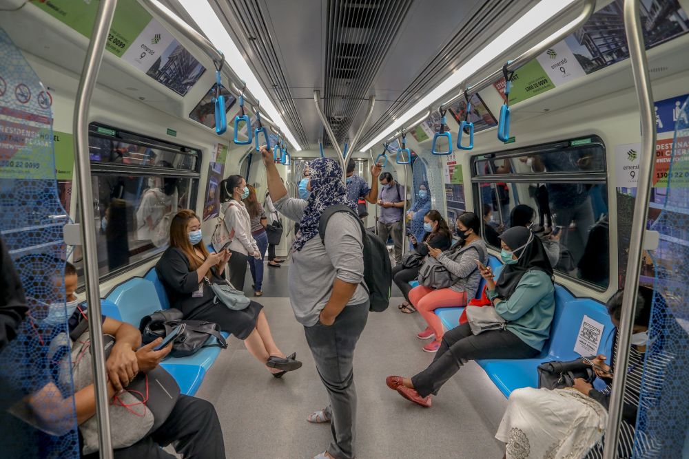 Commuters are pictured aboard an MRT train in Kuala Lumpur May 4, 2020. u00e2u20acu201d Picture by Firdaus Latif