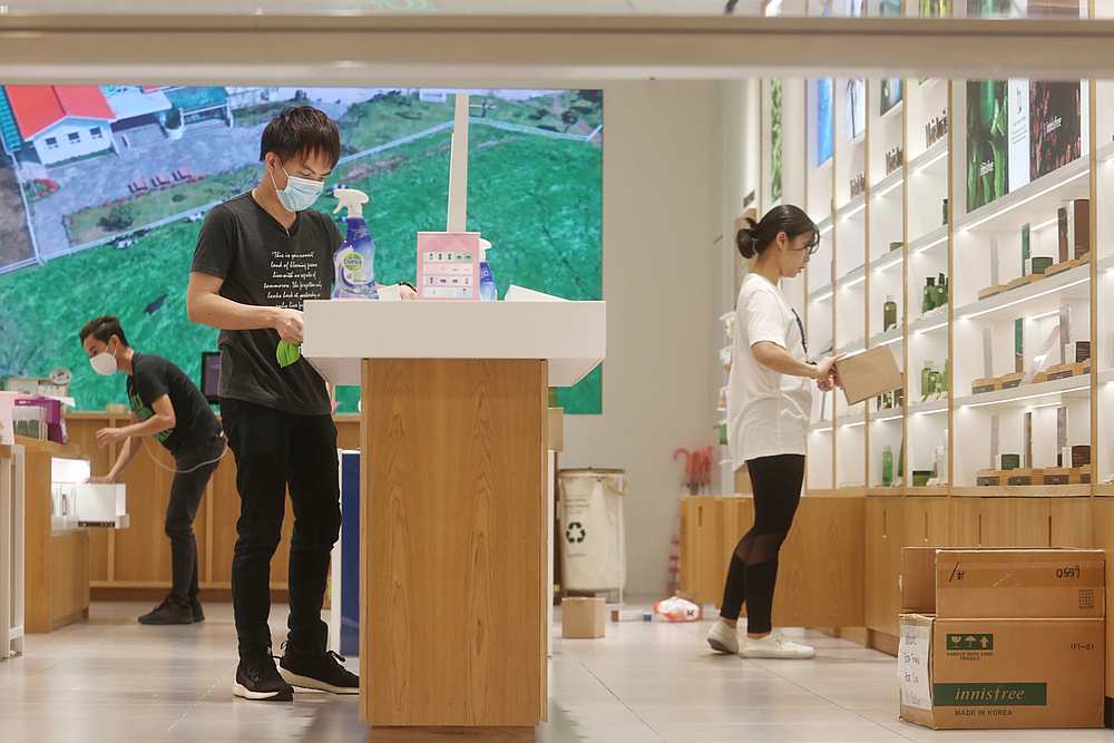 Staff carry out sanitisation and cleaning work at a shop before opening at the Mid Valley shopping mall in Kuala Lumpur May 4, 2020. — Picture by Choo Choy May