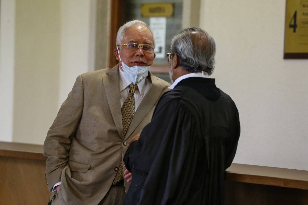 Datuk Seri Najib Razak speaks to his lawyer Tan Sri Muhamaad Shafee Abdullah during a break at the Kuala Lumpur High Court May 20, 2020. u00e2u20acu201d Picture by Yusof Mat Isa