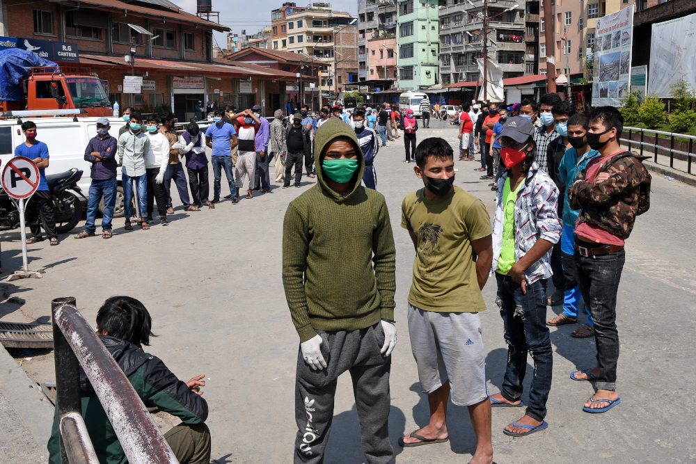 People stand in queues as they wait to be tested for a coronavirus test at Kalimati vegetable market during a government-imposed nationwide lockdown in Kathmandu May 14, 2020. u00e2u20acu201d AFP