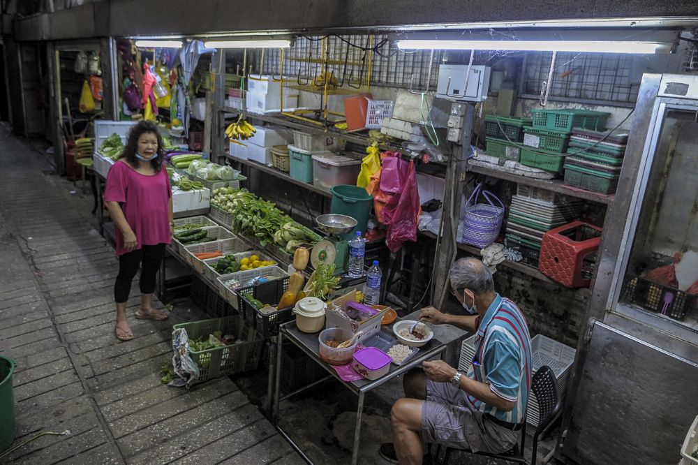 Petaling Street wet market trader Christina Tan and her husband are pictured at their stall on the first day of the conditional movement control order in Kuala Lumpur, May 4, 2020. u00e2u20acu201d Picture by Shafwan Zaidon
